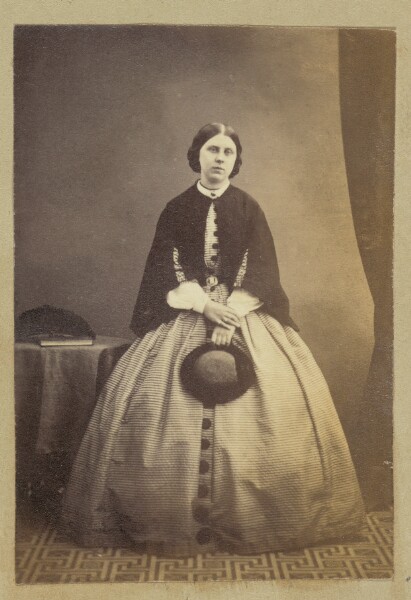 Unknown, [Portrait of woman holding hat]