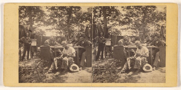 Unknown, [Group of Civil War soldiers at camp site, one man seated, sewing his shirt]