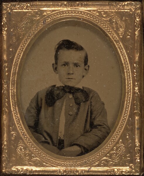 Unknown, [Young boy wearing floppy bow tie seated]