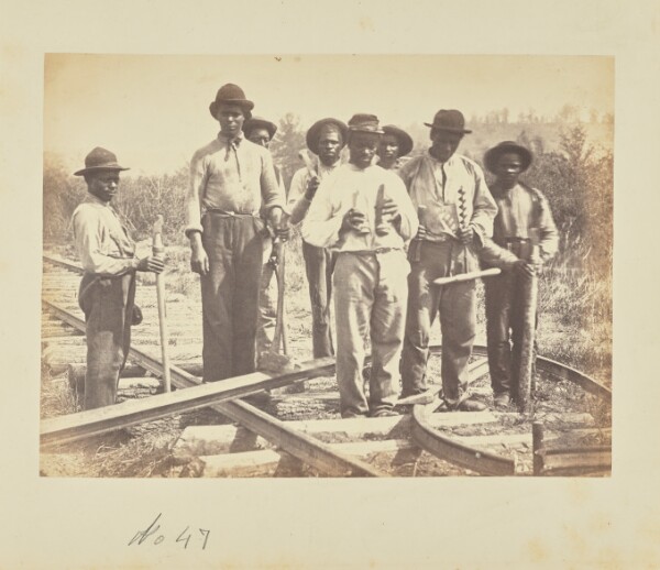 A. J. Russell, [Workers standing on railroad tracks]