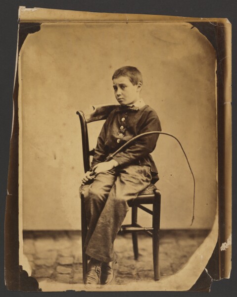 Unknown, [Boy holding a whip]