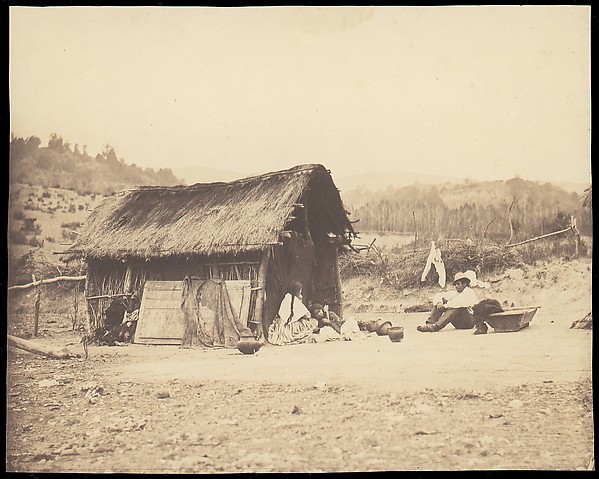 Unknown, [Family Seated by Thatched Hut, South America]