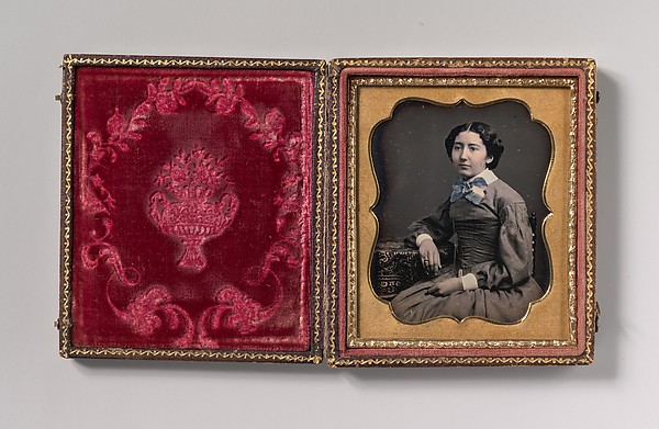 Unknown, [Seated Young Woman Wearing Collar with Large Bow, Resting Arm on Table]