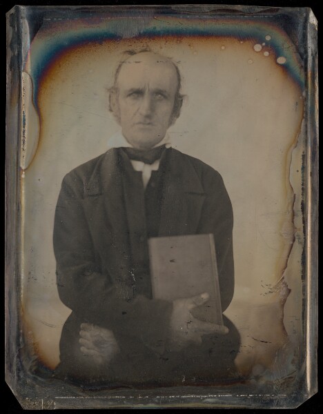Unknown, [Portrait of a Man with Muttonchop Whiskers Clutching a Book]