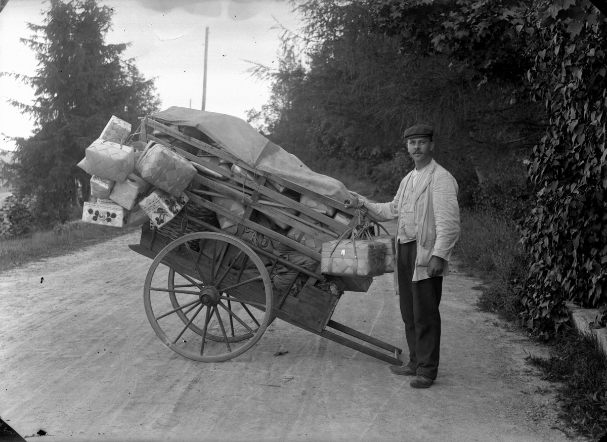 Gustaf Ferdinand Hallberg, A man with a carriage loaded with baskets. The basket maker Pehr Jönsson from Rävatorp in Kärrabod on a visit to Svennevad. The picture is taken on the road off North Hyddan, 1913. (The data obtained by Gunnar Larsson, Pålsboda.)