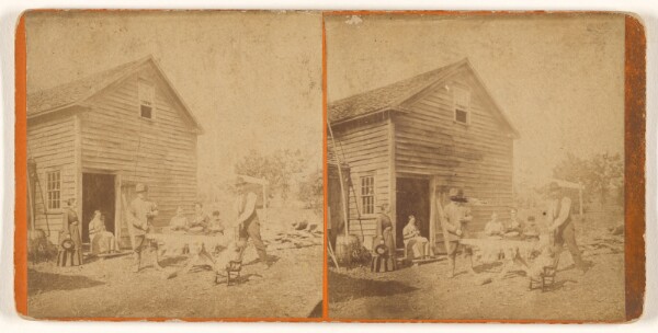 Unknown, [Group of men and women outside a barn, three women seated at a table]