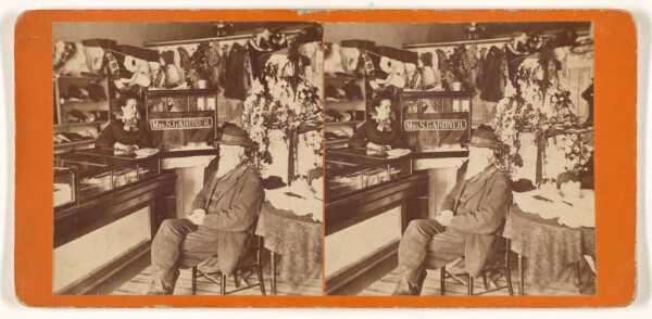 Unknown, [Interior of Mrs. S. Gardner's store, elder man with long white beard seated at front of counter with sign, woman behind counter]