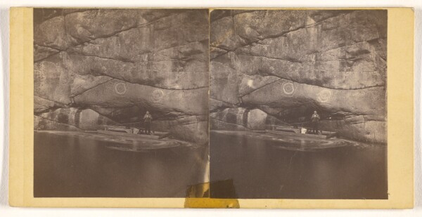 John P. Soule, [Man standing in raft on lake with cliffs behind with graffiti]
