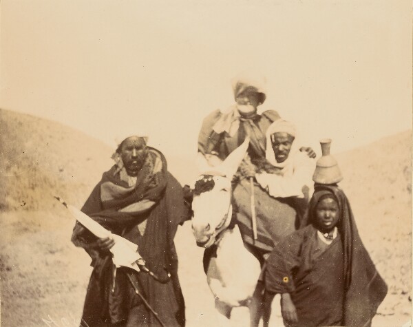 Unknown, [Men with woman riding mule]
