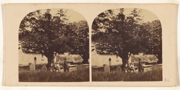 Unknown, [Cemetery with several people near tomb with large tree]