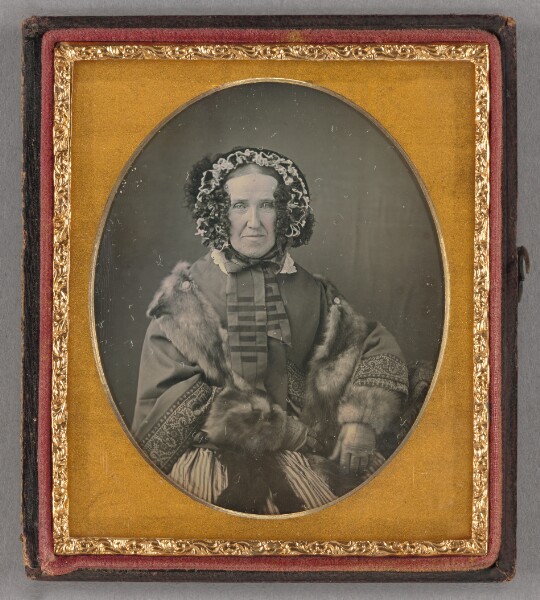 Unknown, [Portrait of an elderly woman wearing a hat, fur coat and gloves, seated]