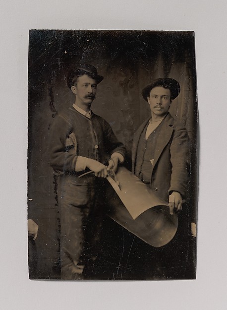 Unknown, [Two Tinsmiths Cutting a Curled Sheet of Metal]