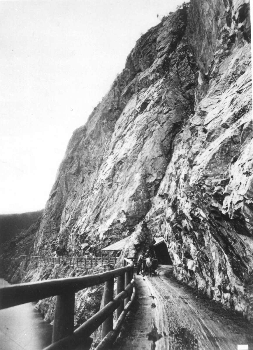 Knud Knudsen, (U.nr.) Parti fra Kvamskleiva, Vang O, Valdres. Veiparti med gjerde ved fjellvegg og tunnel. Fra prospektserie (nr.?) tatt av fotograf Knud Knudsen (1832-1915).