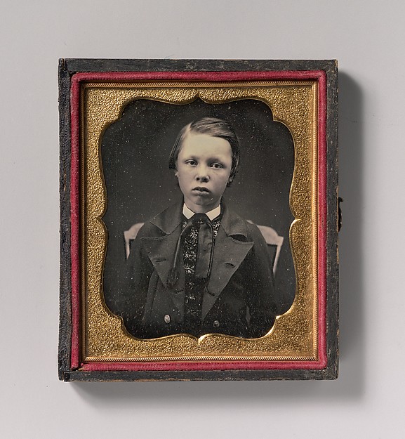 Unknown, [Boy in Wide Lapelled Coat, Seated in Chair]