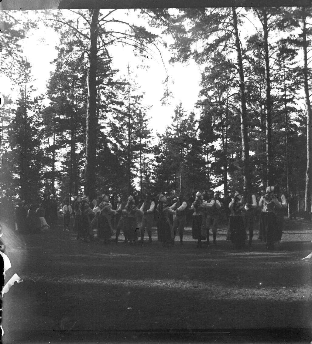 Unknown artist, Folk dance on a grass pitch among tall pines. Probably on the Boundary.